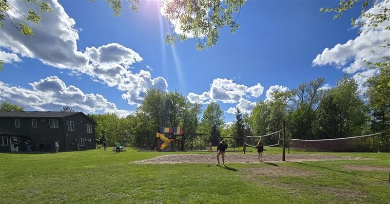 Sunny day on the grounds at St. Croix River Resort with volleyball and playground