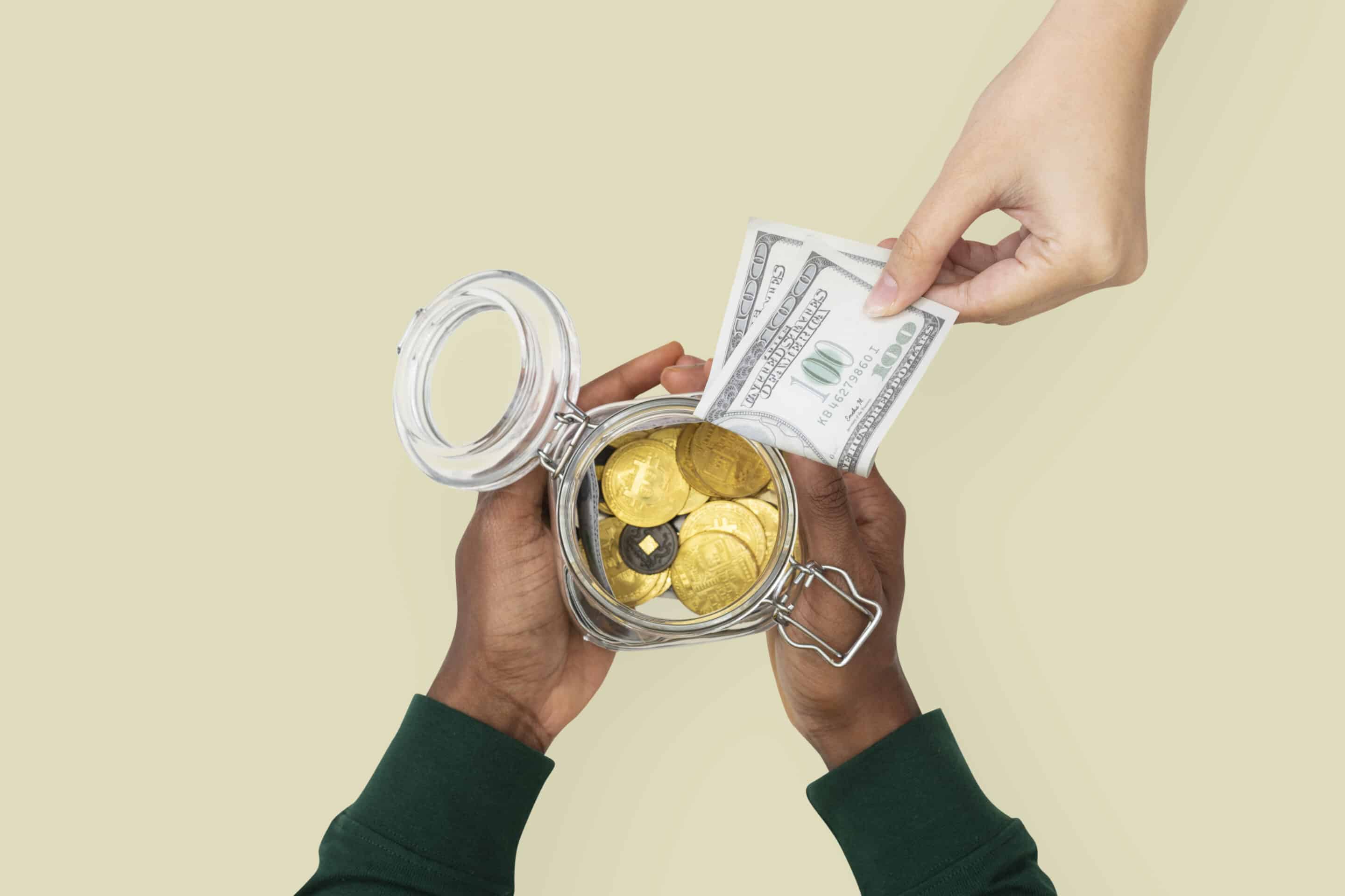money jar held by hands finance savings concept scaled